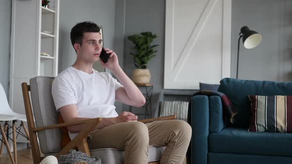 Man Excited for Success While Talking on Phone