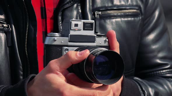 A Man Uses Zoom on a Camera - Closeup