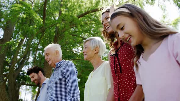 Multi-generation family walking together in the park