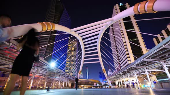 4k Time-lapse of People walking at Chong Nonsi skywalk at night, Bangkok, Thailand