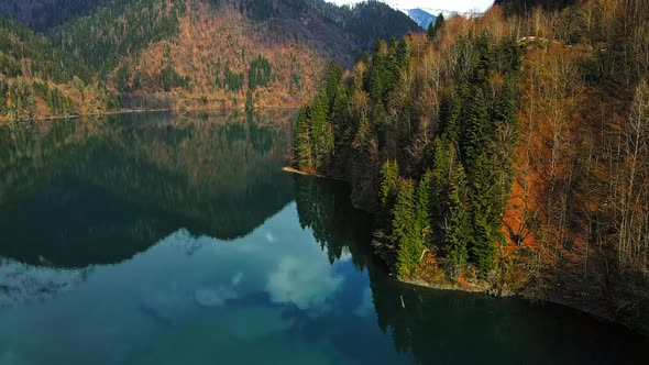 Clear Blue Mountain Lake with Reflection of Clouds on the Water