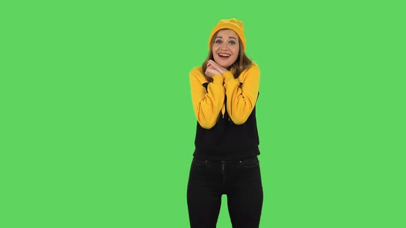 Modern Girl in Yellow Hat with Shocked Surprised Wow Face Expression Is Tender Smiling. Green Screen
