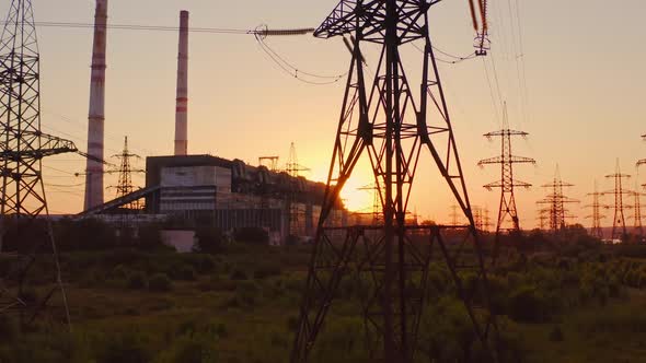 Tall voltage tower. Distribution and supply electricity at sunset. 