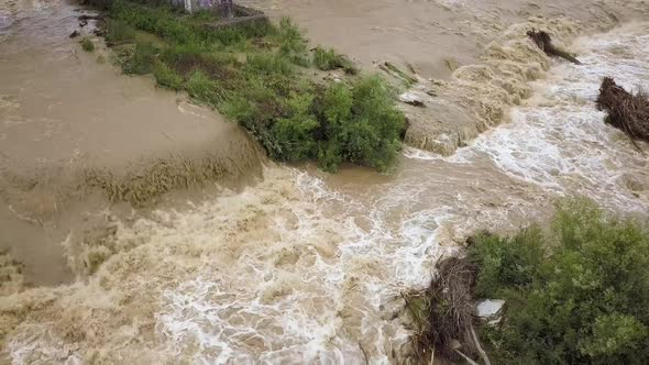 Aerial View of Wide Dirty River with Muddy Water in Flooding Period During Heavy Rains in Spring