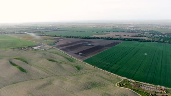 Aerial view of green agriculture fields with growing crops