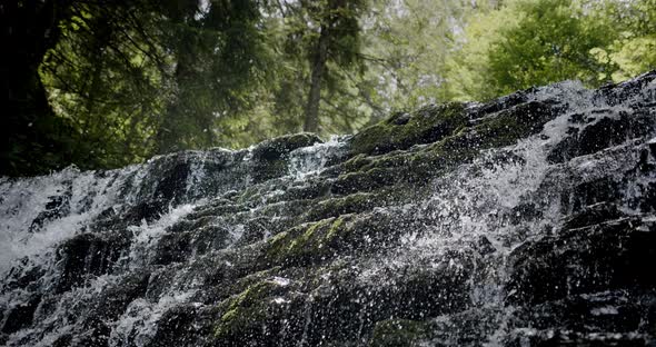 Stunning Slow Establishing Shot of River with Waterfall in Forest in Summer. Slow Motion V5