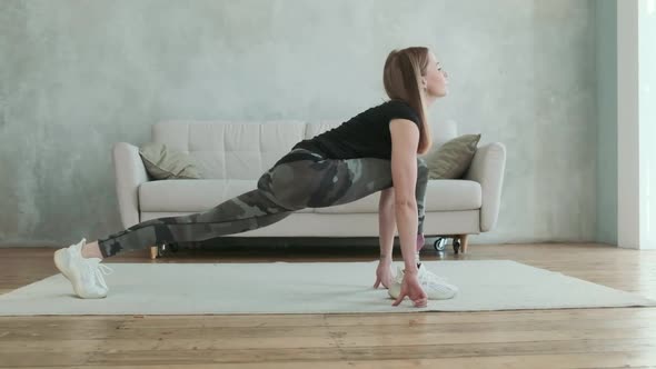 Young attractive woman with prosthetic leg does stretching exercise