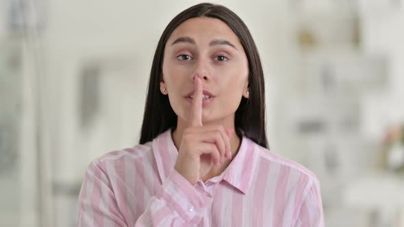 Strict Latin Woman Putting Finger on Lips, Quiet Sign 