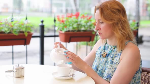 Happy Smiling Woman Making Green Tea Outdoors. Summer Background. Healthy Eating Concept. Shallow