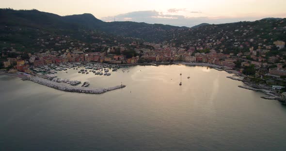 Romantic golden hour aerial view over charming Italian coastal town, Liguaria