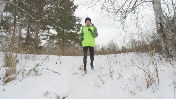 Active Woman Running Downhill in Winter