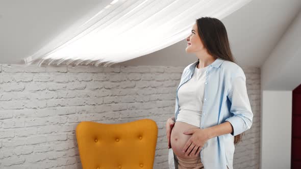 Domestic Pregnant Young Woman Dreaming Looking Out Window Enjoying Weekend at Home