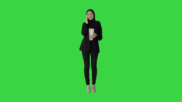Arabic Business Woman Wearing Hijab Speaking on the Phone on a Green Screen Chroma Key