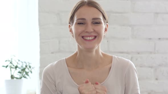 Beautiful Young Woman Celebrating Success in Office