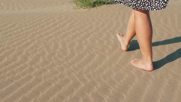 Slow Motion a Young Girl Wearily Falls on Her Knees on the Sand