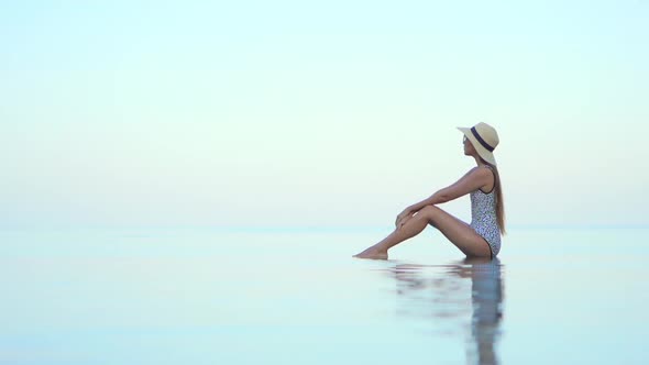 Young asian woman enjoy around outdoor swimming pool for leisure