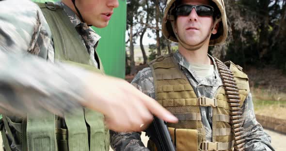 Military soldiers interacting with each other during training exercise