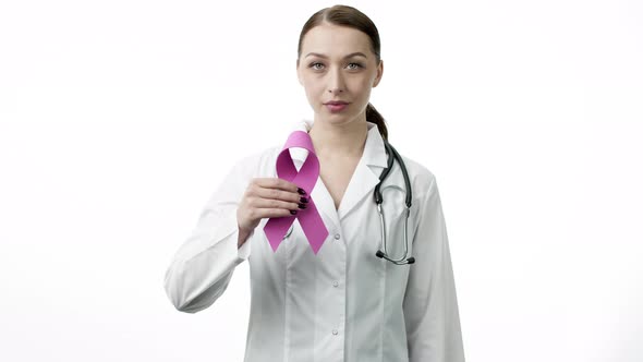 Smiling Doctor Showing Pink Ribbon Symbol of Breast Cancer on White Background