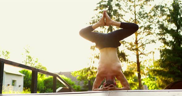 Man Wearing Sport Clothes Stretching in Summer Park