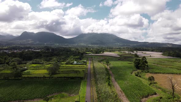 Still aerial footage of Arenal Volcano and Cerro Chato in Alajuela, Costa Rica. Vehicles driving alo