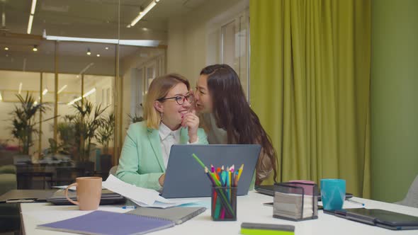 Positive Female Coworkers Whispering Office Gossip