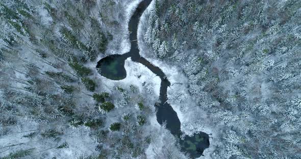 Aerial View of Spring Water Lake and River in Snowy Winter Forest