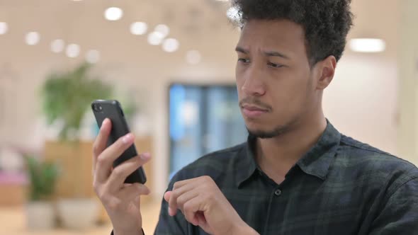 African American Man Checking Smartphone