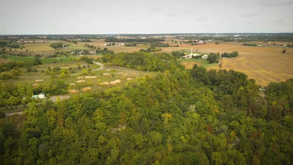 Cinematic drone shot of large farming fields in the countryside,