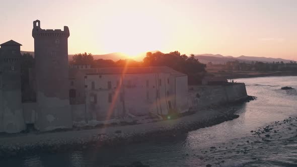 Santa Severa Beach and Castle at sunrise, Province of Rome, Italy. Aerial drone view