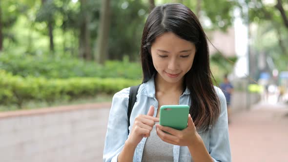 Woman use of mobile phone at street