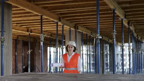 Architect or engineer working, browsing building project indoor of construction site