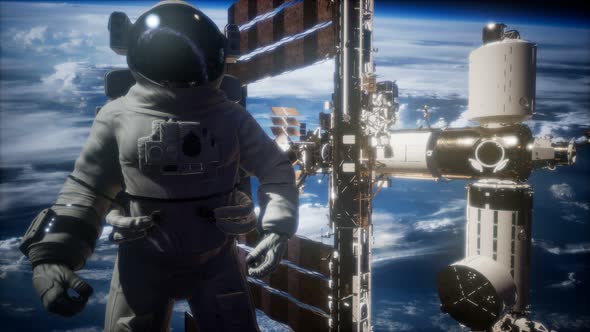 International Space Station and Astronaut in Outer Space Over the Planet Earth