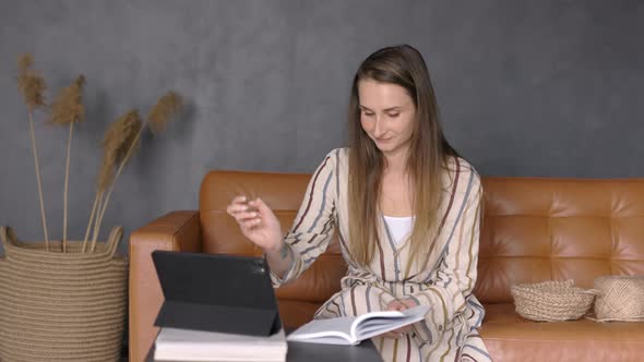 Young Woman learning from Home, taking Notes on Online Class, Learning Knitting, Tutorials, Indoor