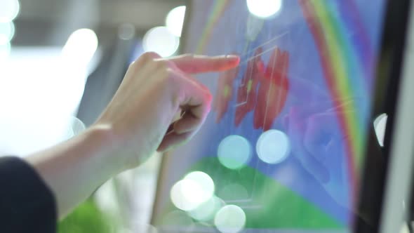 Womanl Paints On A Large Touch Screen Monitor