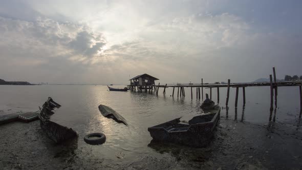 Abandoned boat and fishing house under ray.