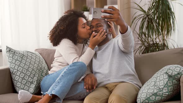 Happy Couple with Smartphone Taking Selfie at Home