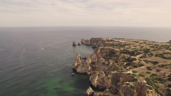 Headland and ocean. Algarve, Lagos rocky coastline. Gorgeous limestone cliffs.