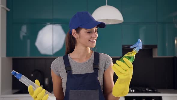 Woman in Workwear Choosing Green Detergent Among Two Cleaning Agents Being