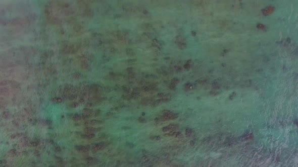 Aerial shot of turquoise Hawaiian waters of Kawela Bay Beech Park near the Turtle Bay Resort.