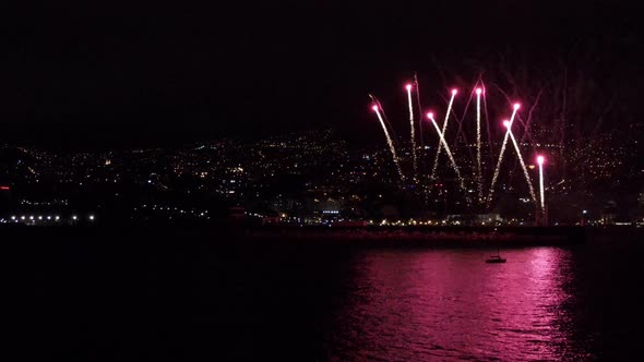 Fireworks over the ocean coast at the Funchal city in Portugal, Madeira.