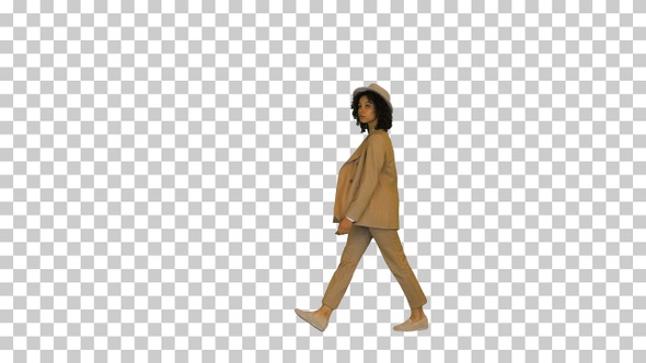 Young black lady wearing a hat walking, Alpha Channel
