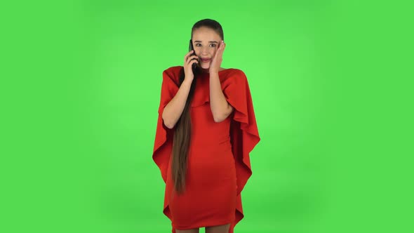 Pretty Young Woman Is Talking for Mobile Phone and Rejoicing. Green Screen