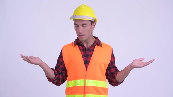 Young Happy Hispanic Man Construction Worker Comparing Something