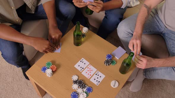 Smiling Male Friends Playing Cards at Home