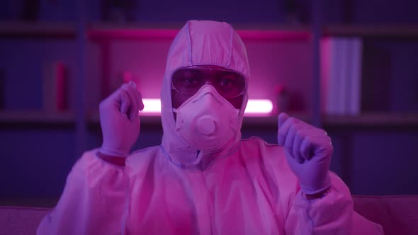 Funny Black Man Wearing Hazmat Suit Dancing In Dark Room