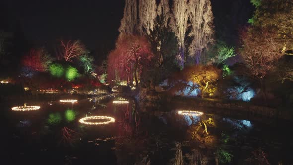 Lake in Garden decorated with Christmas lights, Wide shot, Night