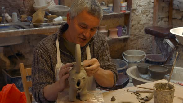 Potter working on clay sculpture