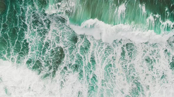 Huge Turquoise Ocean Waves on Foamy Surface Aerial View