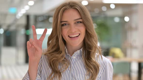 Portrait of Successful Businesswoman Showing Victory Sign