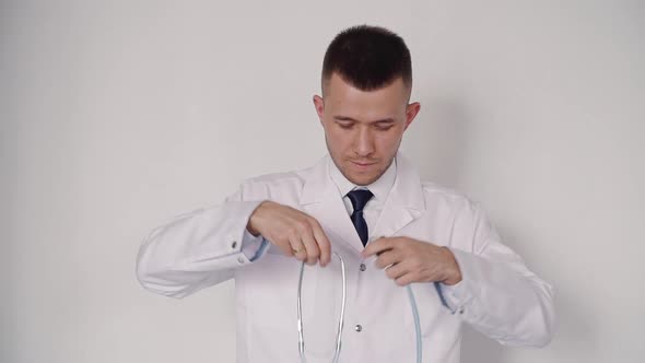 Confident Intelligent Medical Worker Is Standing and Looking Straight To Camera alt